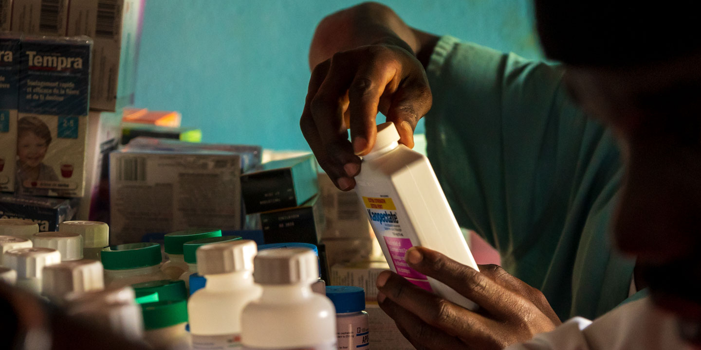 Staff examining medicine bottles