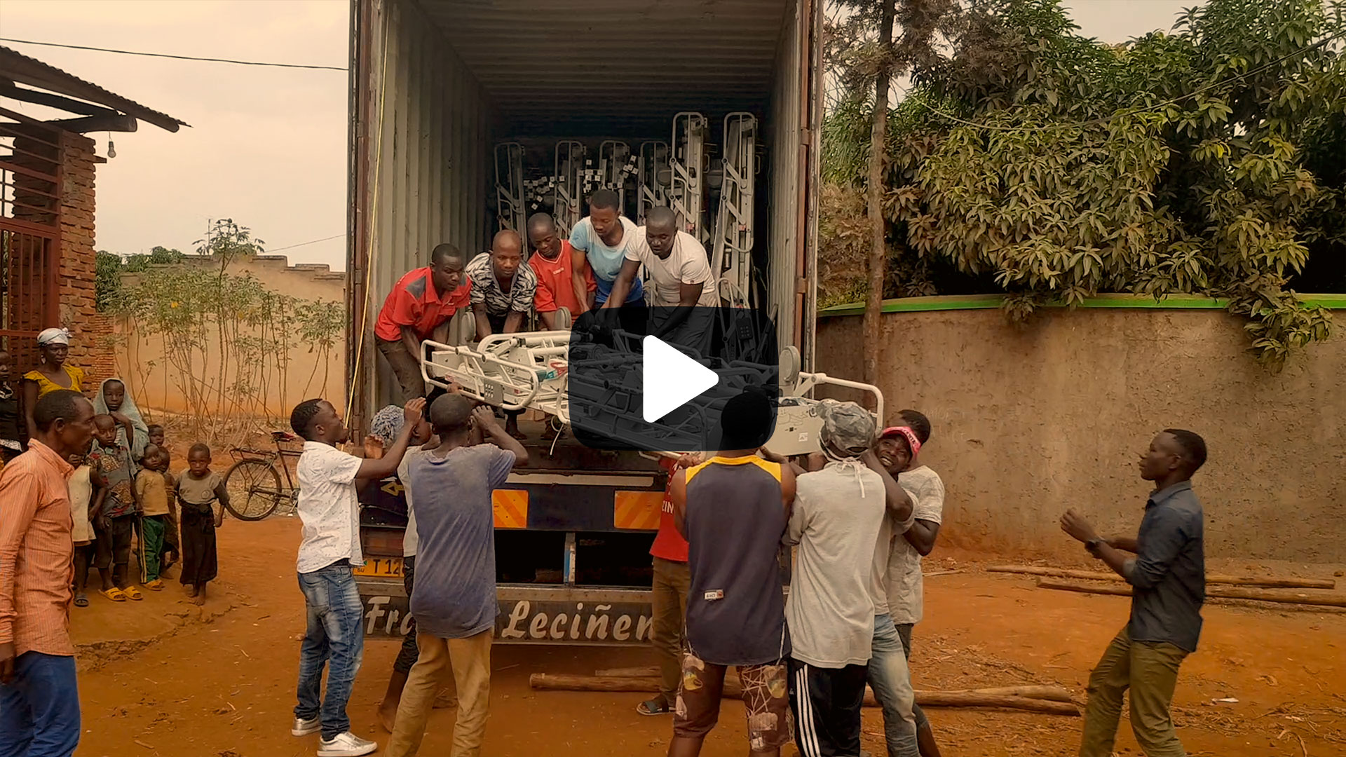 Preview image for video update about the Container 2021 project, shows people in Burundi unpacking the container
