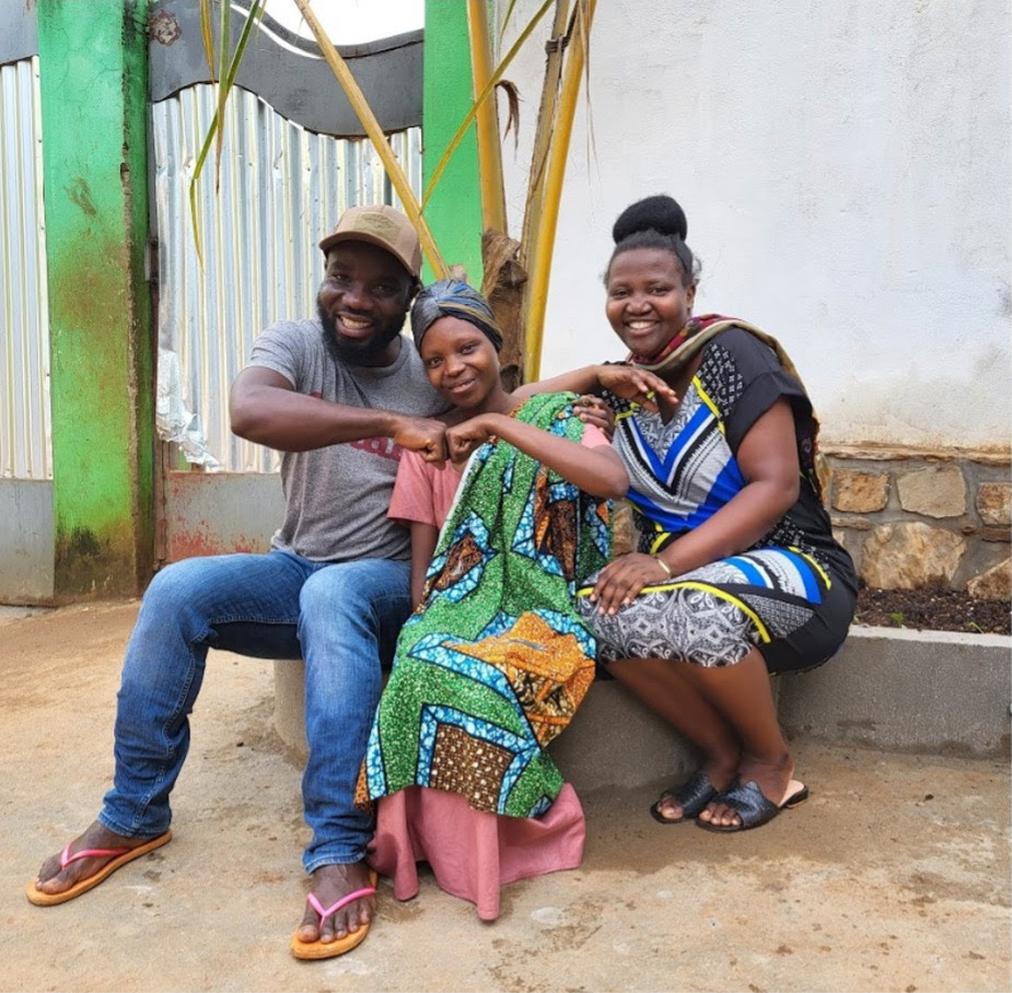 Photo of Deborah with Jackson and Aceline, as she is preparing to go Bujumbura for her fourth cancer treatment.